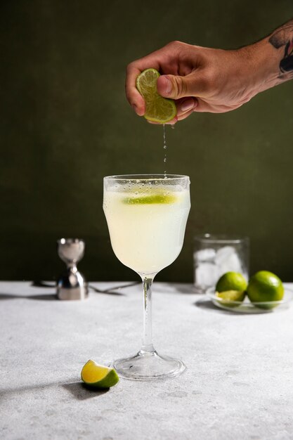 Hand squeezing lime for daiquiri cocktail