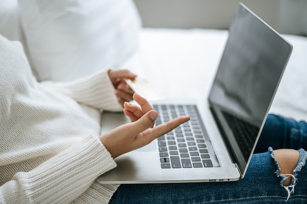 The hand that is put on the laptop.