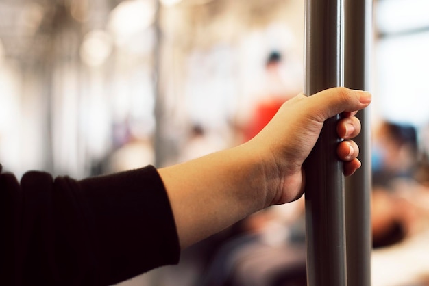 Free photo hand touching a coronavirus contaminated train handrail