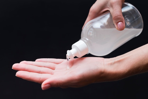 Hand using hand sanitizer