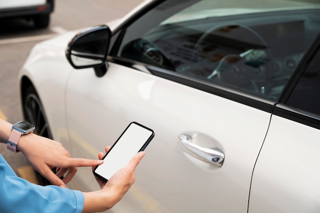 Hand using  phone to lock car