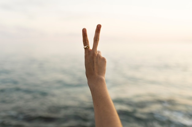 Hand wearing ring at seaside