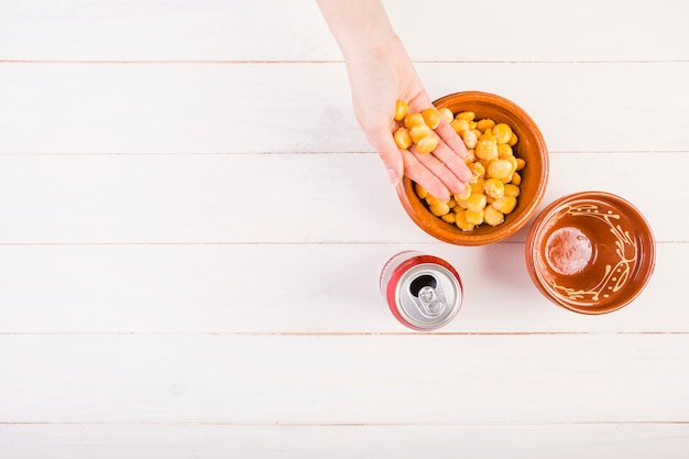 Hand with beans on kitchen table