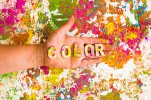 Free photo hand with color title on bright dry colours