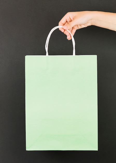 Free Photo hand with green shopping packet