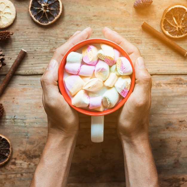 Free Photo hand with hot beverage near spices