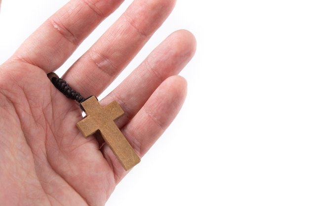 Hand with rosary catholic cross isolated on white background