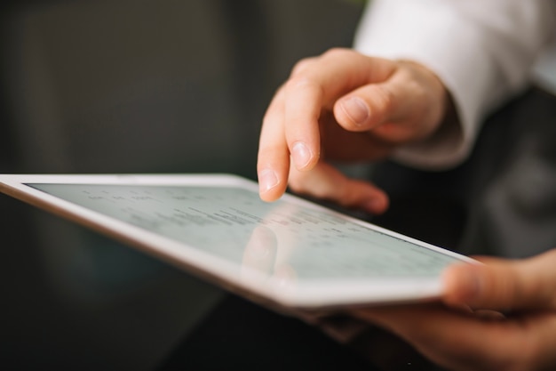 Hand of worker using tablet