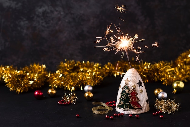 Free photo handheld firework with christmas decorations