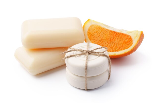 Handmade citrus soap and fresh fruit on white background