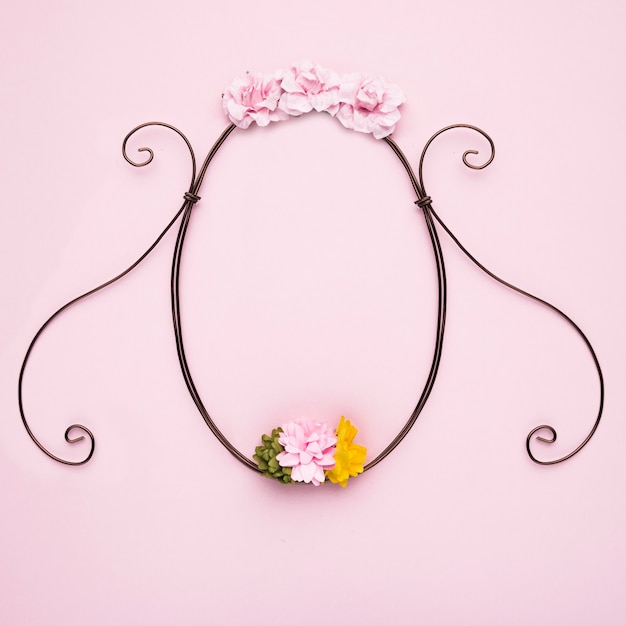 Free photo handmade flower decorative empty frame on pink backdrop