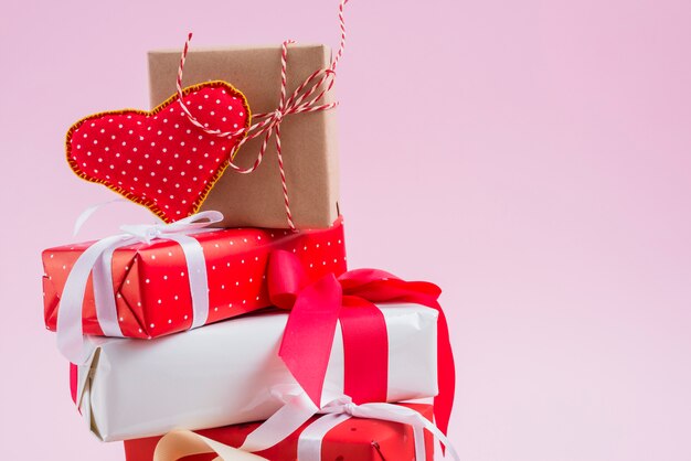 Handmade heart on heap of presents