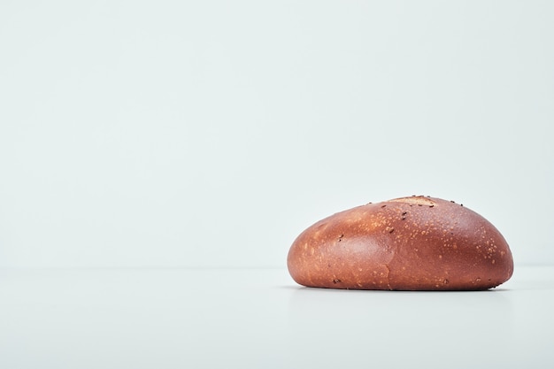 Handmade oval bread on grey table.