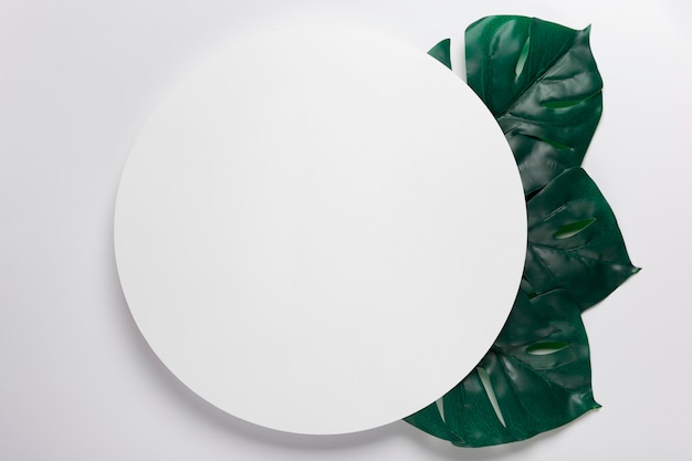 Handmade paper circle with leaves beside