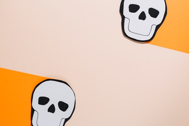 Free Photo handmade skulls laid on orange paper