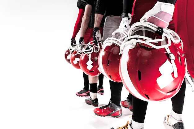 The hands of american football players with helmets