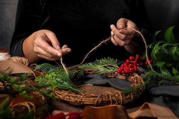 Free photo hands assembling advent wreath