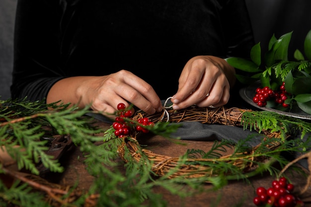 Free photo hands assembling advent wreath