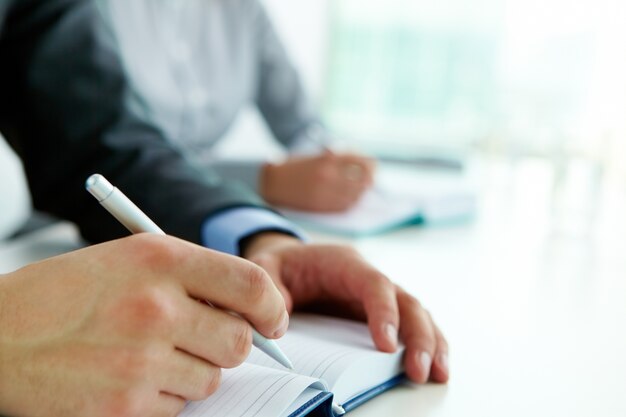 Hands close-up of worker writing