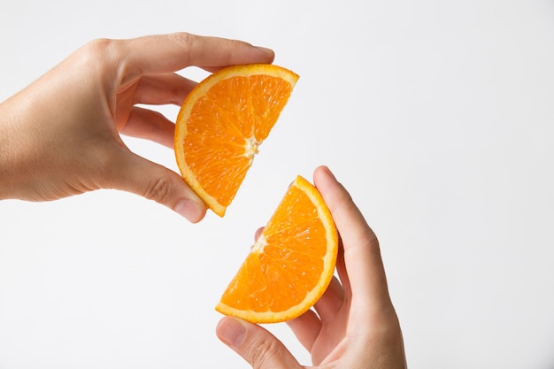 Hands connecting cut orange sections