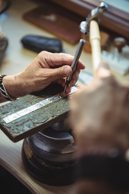 Hands of craftswoman using tools