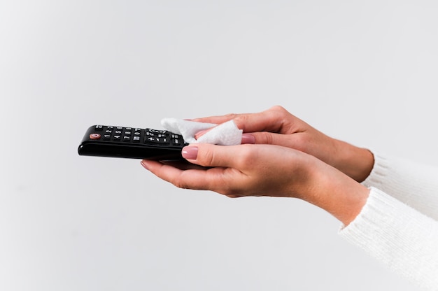 Free Photo hands disinfecting remote controller