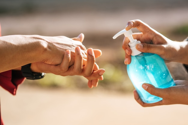 Free photo hands at the gel bottle to wash hands and squeeze for others to wash hands.