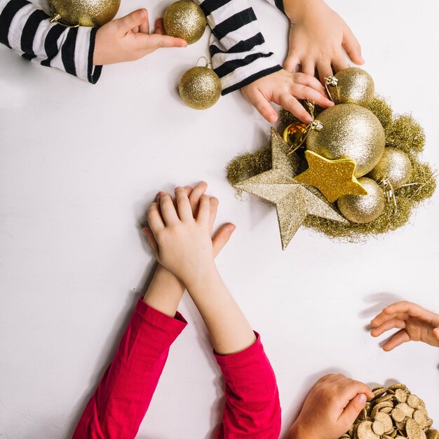 Hands and golden christmas ornaments