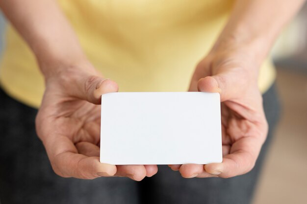 Hands holding blank business card