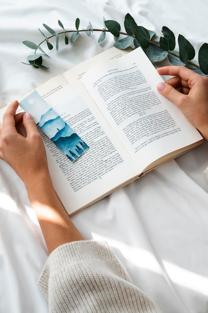 Hands holding book high angle