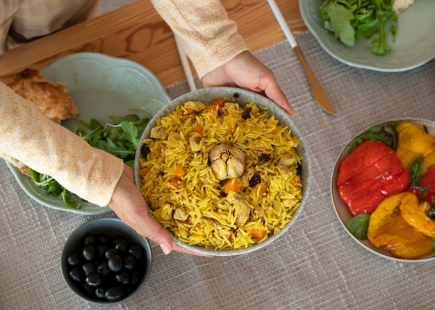 Free Photo hands holding bowl of food top view