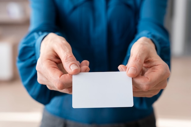 Free Photo hands holding business card high angle