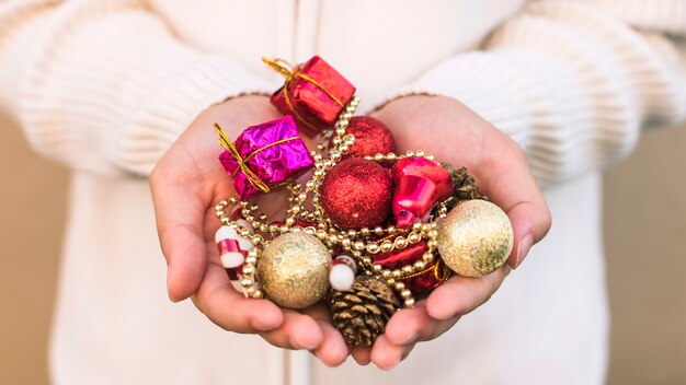 Hands holding christmas ornaments