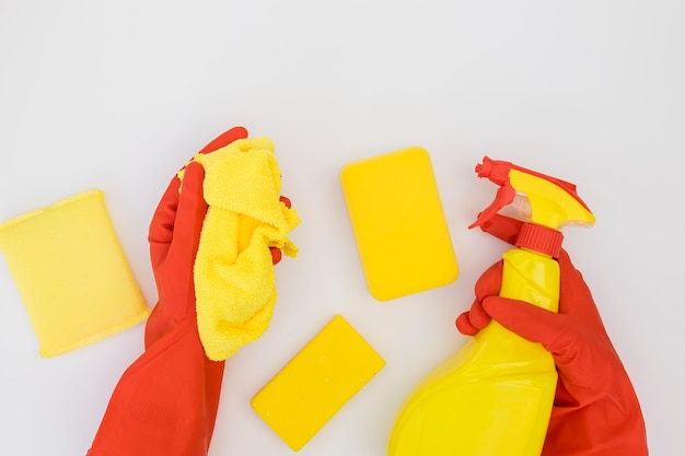 Hands holding cleaning supplies