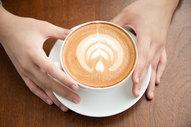 Hands holding coffee cup