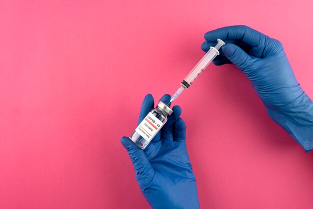 Hands holding coronavirus vaccine close up