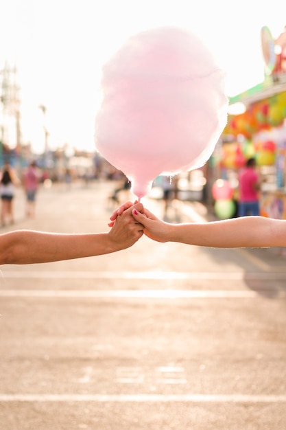 Free photo hands holding a cotton candy