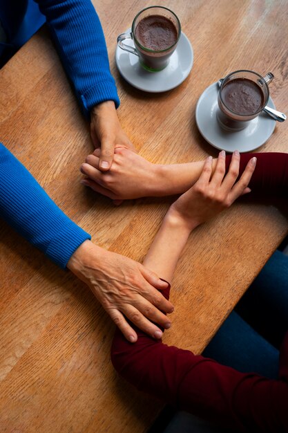 Hands holding each other for support