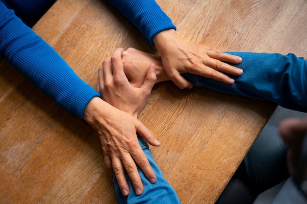 Hands holding each other for support