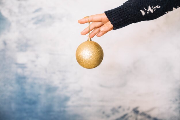 Hands holding elegant christmas ball