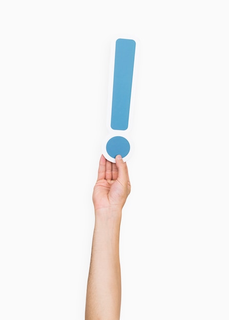 Free photo hands holding exclamation point symbol