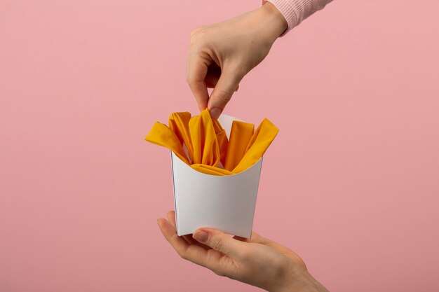 Hands holding fries made out of clothes