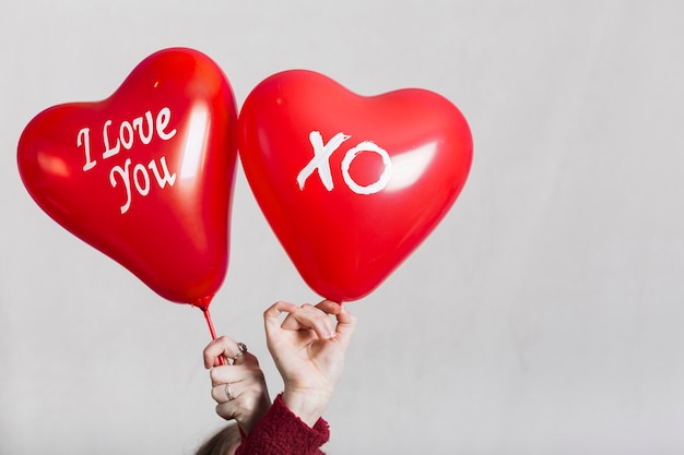 Free photo hands holding i love you balloons