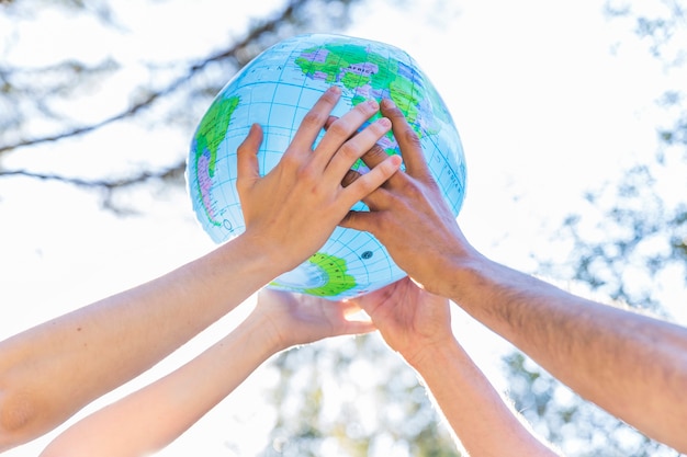 Free photo hands holding inflatable globe