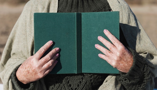 Free Photo hands holding open book front view