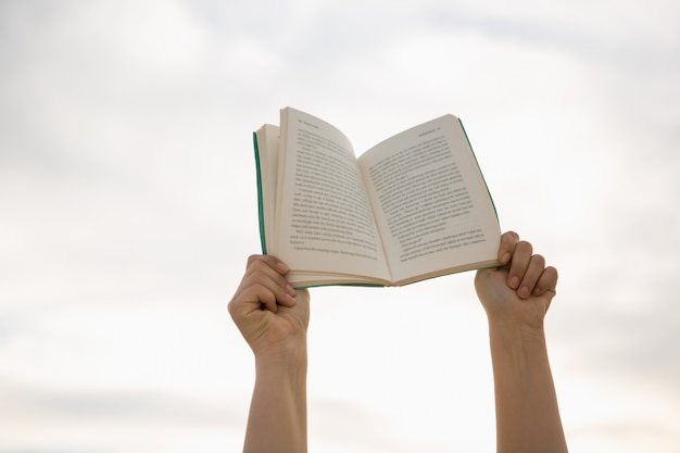 Hands holding open book