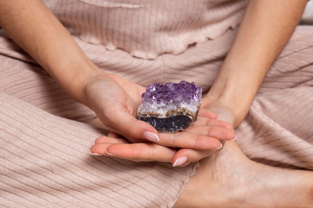 Free photo hands holding purple crystal