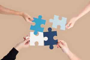 Free photo hands holding puzzle business problem solving concept