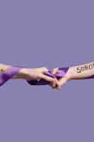 Free photo hands holding a ribbon while covered in empowering words