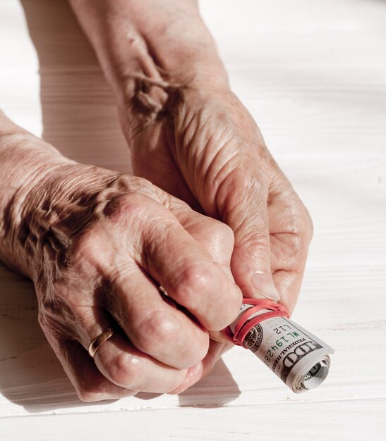 Hands holding a roll of money